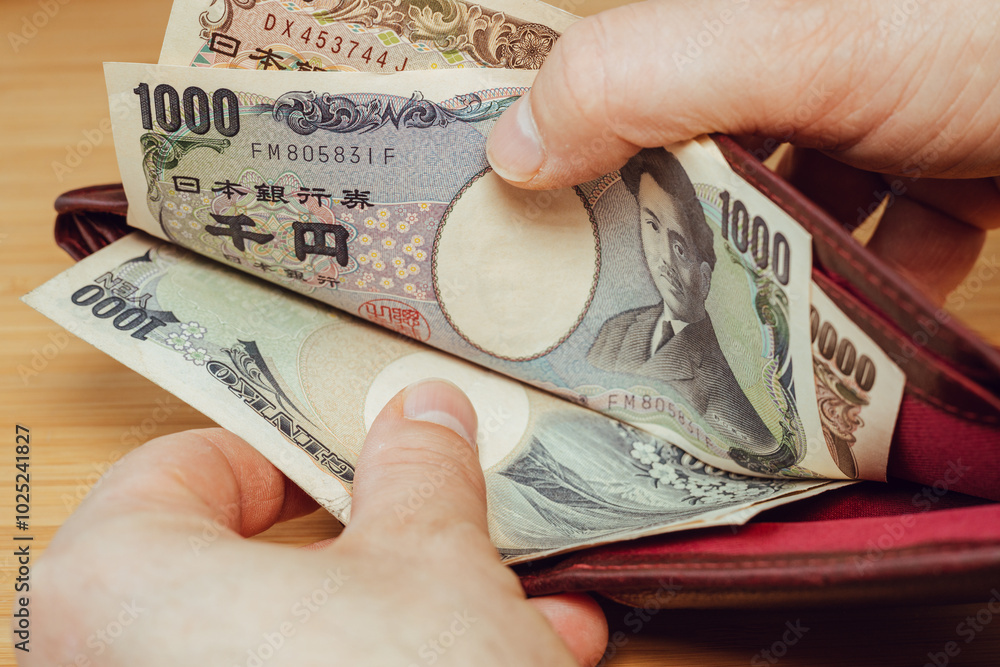 Japan money. Hand taking money out of wallet. Japanese yen, financial concept