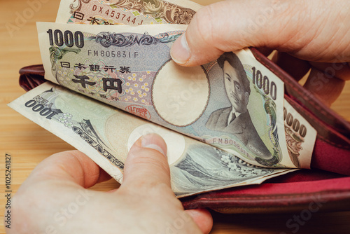 Obraz na płótnie Japan money. Hand taking money out of wallet. Japanese yen, financial concept w salonie