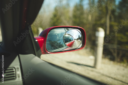An image of a car mirror taken from the passenger seat. 