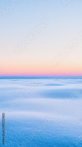 Enchanting winter twilight skies painted with soft pastels over a serene, snow-covered landscape at dusk