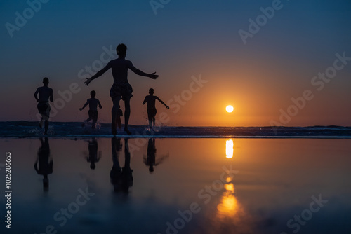 A group of people running along the beach at sunset, their silhouettes and reflections beautifully highlighted by the golden light of the setting sun