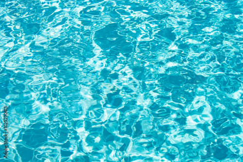 Ripped water in swimming pool. Surface of blue swimming pool, background of water.