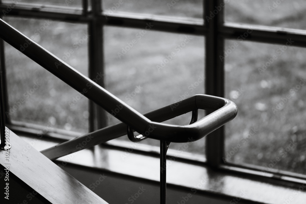 A simple black and white photograph of a stair rail. A simple black and white photograph of a stair rail.