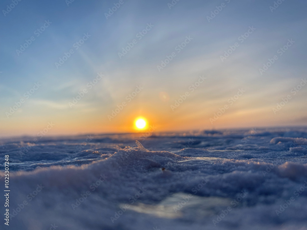 Low angle image of frozen snow covered lake at sunset Low angle image of frozen snow covered lake at sunset