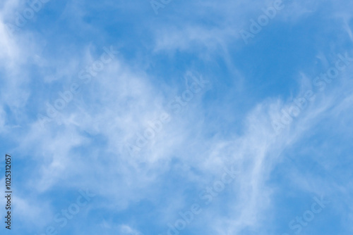 The afternoon sky with white soft high cirrus clouds