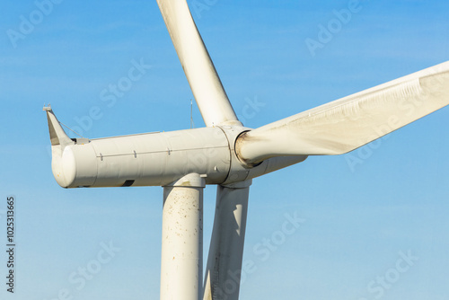 Cuadro en lienzo Close-up of large wind turbine nacelle hub and blades against clear blue sky at