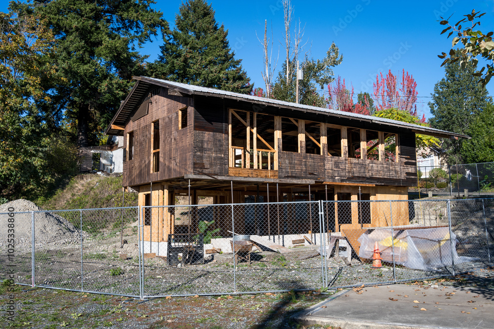 Major remodel and refurbishment of an old wood building, gutted down to the exterior walls and beams, work site on a sunny fall day
Major remodel and refurbishment of an old wood building, gutted down to the exterior walls and beams, work site on a sunny fall day