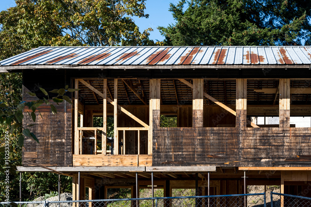 Major remodel and refurbishment of an old wood building, gutted down to the exterior walls and beams, work site on a sunny fall day
Major remodel and refurbishment of an old wood building, gutted down to the exterior walls and beams, work site on a sunny fall day