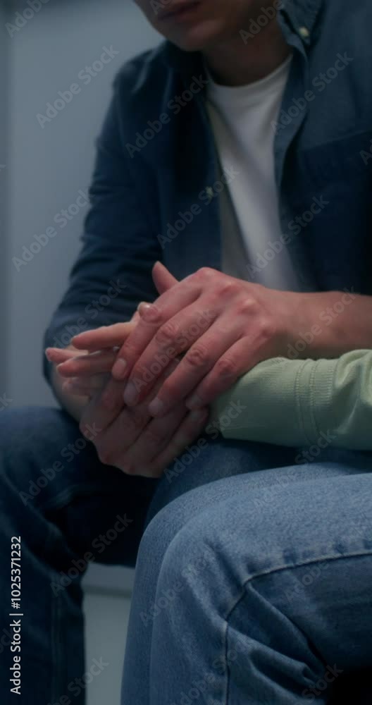 Concerned patient's relatives are waiting sitting on the couch in the hospital corridor Concerned patient's relatives are waiting sitting on the couch in the hospital corridor