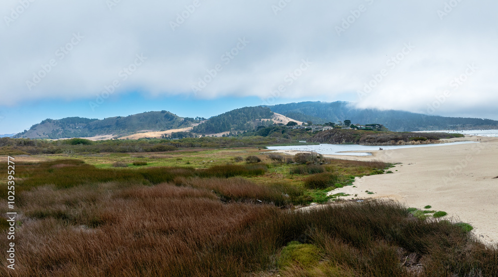 panoramic drone view of meadow with mountains and beach panoramic drone view of meadow with mountains and beach