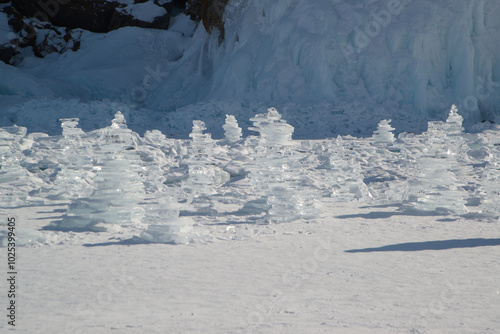 ice piled up in a block of ice against a blue sky on a sunny day. Unusual winter landscape of frozen Lake Baikal Natural cool background. Siberia, Russia. photo