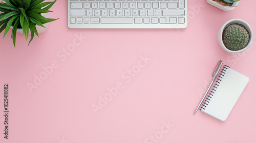 Obraz na płótnie Minimalistic work desk setup featuring a keyboard, notebook, and potted plants on a pink background for a fresh and modern vibe. w salonie