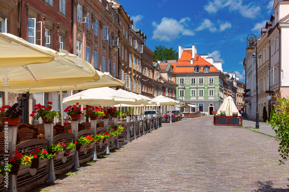 Fototapeta premium Street in the old town with historical buildings, colorful facades, church and street cafes, Warsaw, Poland