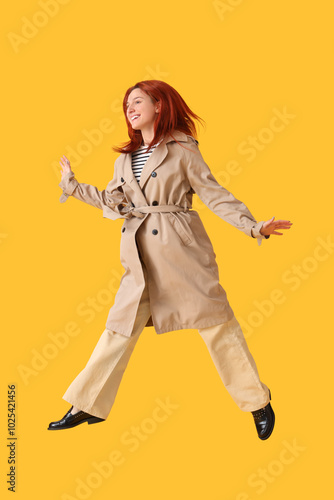 Jumping young woman in autu...