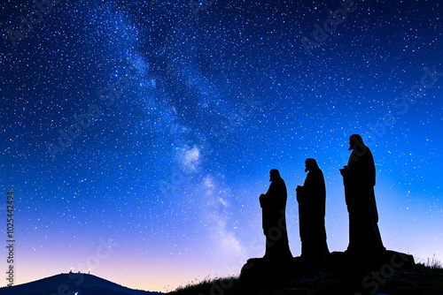 three wise men figurines silhouetted against starry night sky.