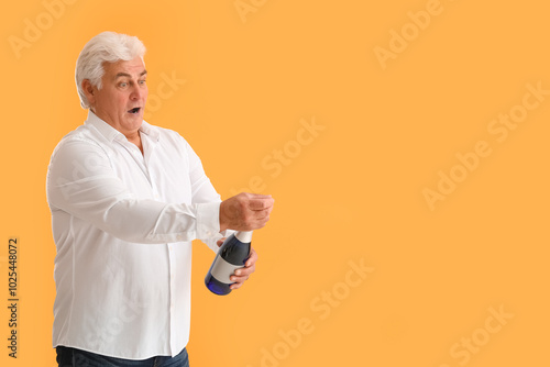 Shocked senior man with bot...