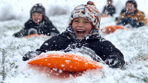 A lively photo of children sledding down a snowcovered hill photo