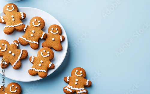 Gingerbread cookies on a plate with a light blue background.