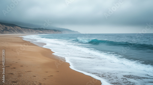 Foggy beach shoreline with gentle waves, tranquil atmosphere and serene ocean view