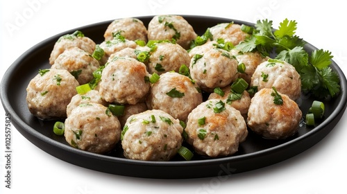 Close-up of a plate of delicious meatballs with herbs, isolated on a white background.