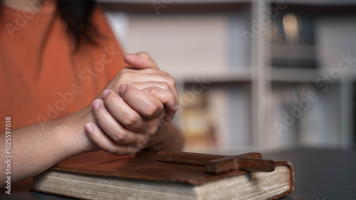 One women wake up early to pray and reading the bible with turn on the worship music.
