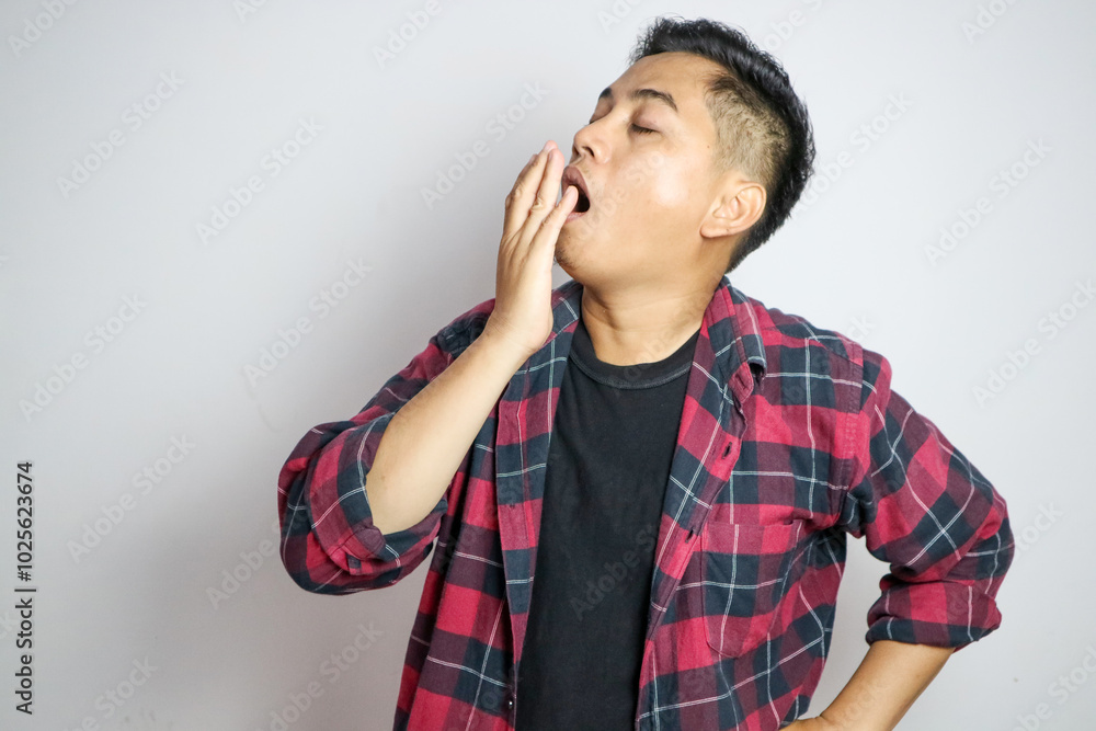 young Asian man with yawn face and sleepy on white background young Asian man with yawn face and sleepy on white background