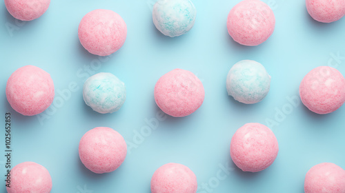 Obraz na płótnie Colorful cotton candy balls in pink and blue arranged in a playful pattern on a bright blue background, perfect for sweet treats and celebrations. w salonie