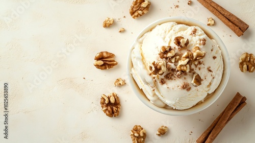 Cottage cheese ice cream with chopped walnuts and maple syrup, isolated on a light beige background with a hint of cinnamon