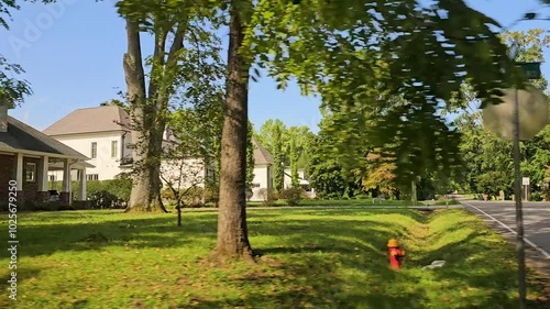 Drive Plate-Side view passing residential area in Nashville, Tennessee on a clear sunny day