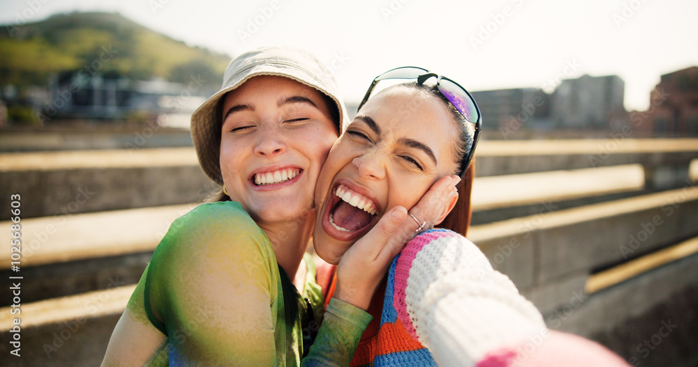 © Flashizzle/peopleimages.com - City, selfie and excited women hug, smile and laugh with cool streetwear on bridge together. Social media, support and happy gen z friends with urban fashion, post and fun bonding in street portrait.