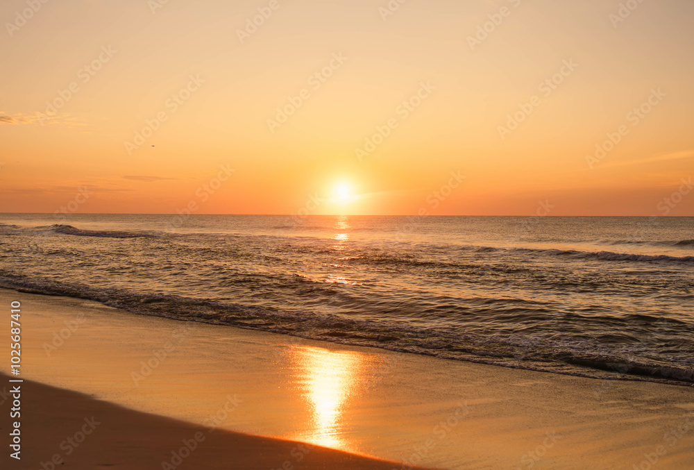 Golden sunset over calm ocean waves