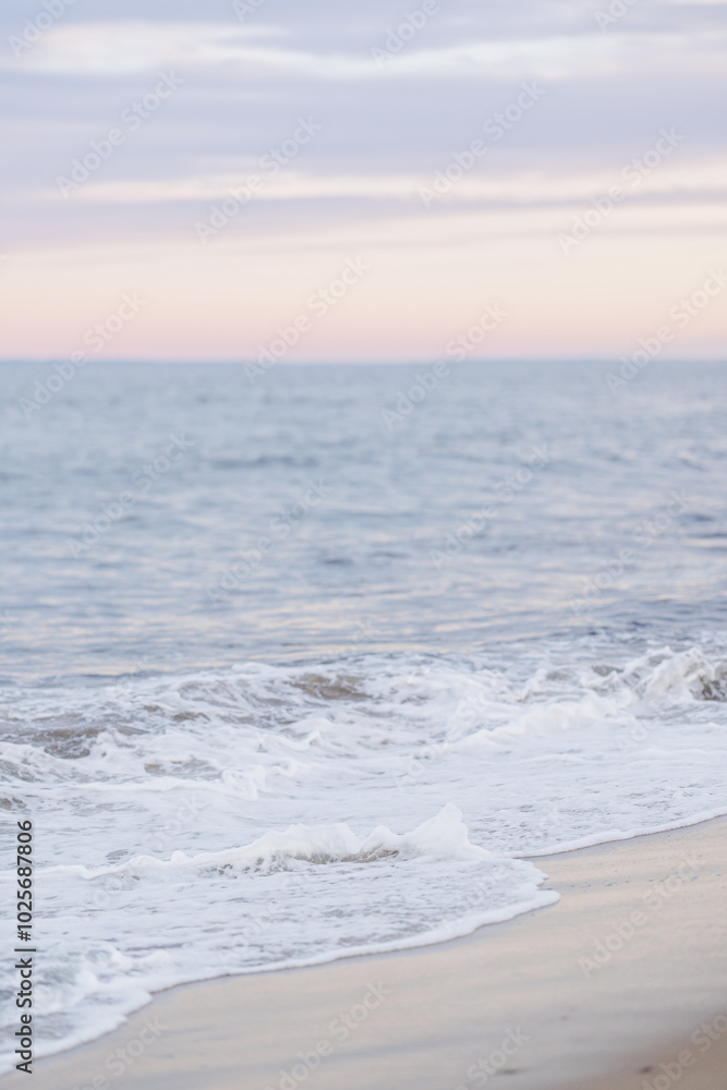 Soft waves gently washing onto the beach at sunset in Newburyport, MA Soft waves gently washing onto the beach at sunset in Newburyport, MA