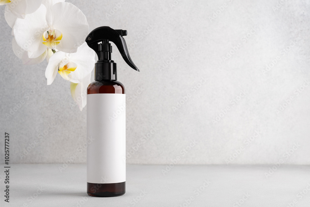 Brown cosmetic trigger sprayer bottle and white orchids Brown cosmetic trigger sprayer bottle and white orchids