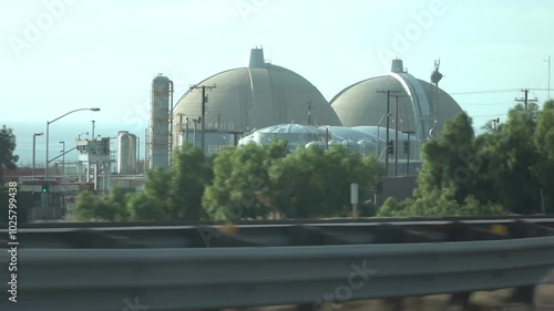The iconic domes of San Onofre Nuclear Generating Station in California with cars passing by on the highway in slow motion 120fps