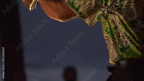 A Hawaiian dancer performing with traditional attire and vibrant motions during a luau in Hawaii in 4k