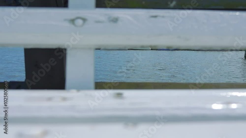 Wallpaper Mural Close-up of a wooden pier railing with water in the background in 4k Torontodigital.ca
