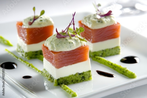 three small squares of cheese and salmon on a white plate