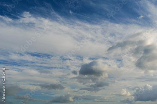 The sky is blue with a few clouds scattered throughout. The clouds are white and fluffy, giving the sky a peaceful and serene appearance