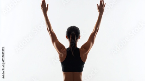 Back view of full-body woman in workout gear, arms raised above head, stretching on white background photo