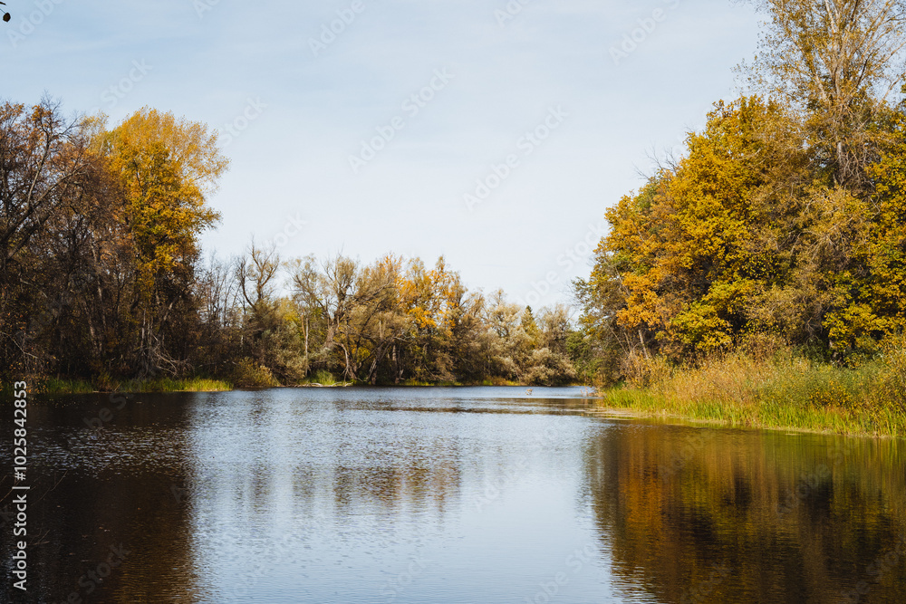 Autumn, a lake, a beautiful landscape, a calm surface of water, a light breeze blows on the surface of the reservoir. Autumn, a lake, a beautiful landscape, a calm surface of water, a light breeze blows on the surface of the reservoir.