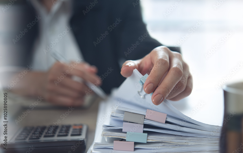 Document management. Businesswoman working with stack of paper files for searching and checking corporate files, document achieves on folders paper on office table, closeup Document management. Businesswoman working with stack of paper files for searching and checking corporate files, document achieves on folders paper on office table, closeup
