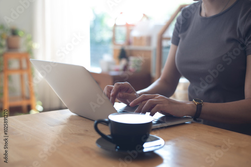 Woman working on laptop computer in coffee shop, freelance at work, people lifestyle. Business woman in csual wear online working on laptop, surfing the internet at, cafe, remote work photo