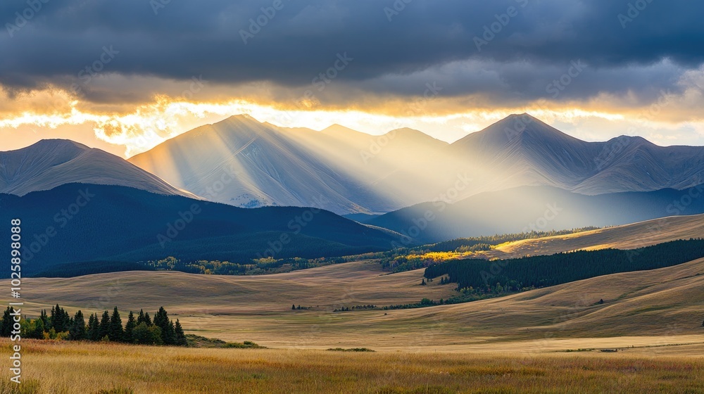 Obraz premium Sunlight Over Majestic Mountain Landscape at Dusk