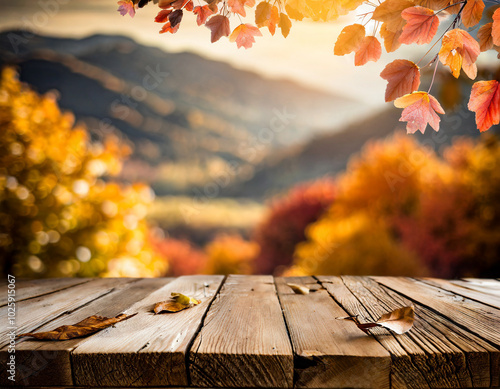 Autumn view of colorful leaves and wooden table in a peaceful mountain landscape at sunset