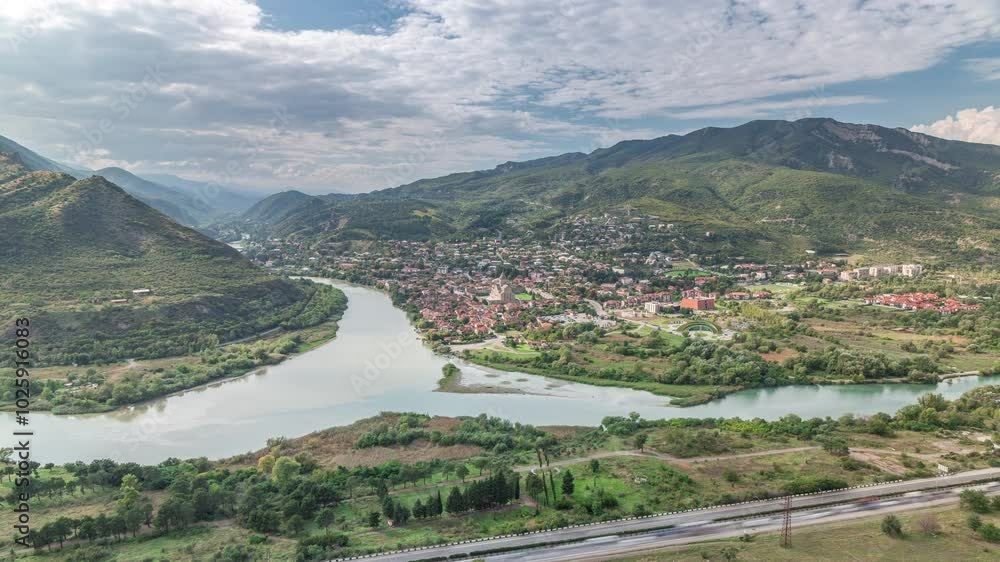 Aerial view of the merger of two rivers Kura or Mtkvari and Aragvi into one timelapse. The ancient capital of Georgia - Mtskheta (right). Beautiful view of the city, Georgia. Clouds passing by Aerial view of the merger of two rivers Kura or Mtkvari and Aragvi into one timelapse. The ancient capital of Georgia - Mtskheta (right). Beautiful view of the city, Georgia. Clouds passing by