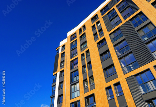 Modern facade building on blue sky. Skyscraper facade. Modern High rise residential facade. Windows of Skyscraper. Architecture building exterior, window house block. High Rise house background.