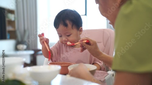 Asian child at home with her grandmother