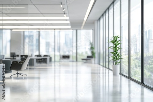 A modern office space featuring large windows, minimalist furniture, and indoor plants, promoting a productive work environment.