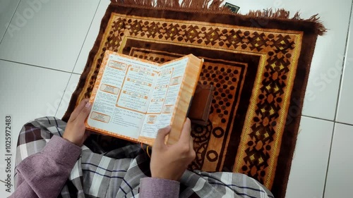 Finish reading the Quran with translation then close it photo