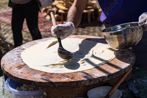 Preparing traditional Georgian cheese bread and tonis puri photo